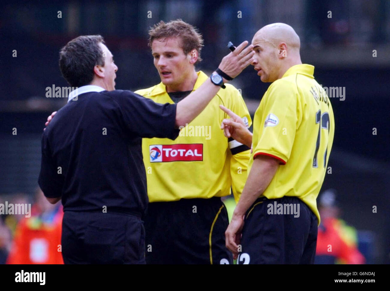 Watford's Neal Ardley and Gavin Mahon talk to referee Alan Wiley after he awarded a penalty to Chelsea during the FA Cup Third Round match at Watford's Vicarage Road ground. Final score 2-2. Stock Photo