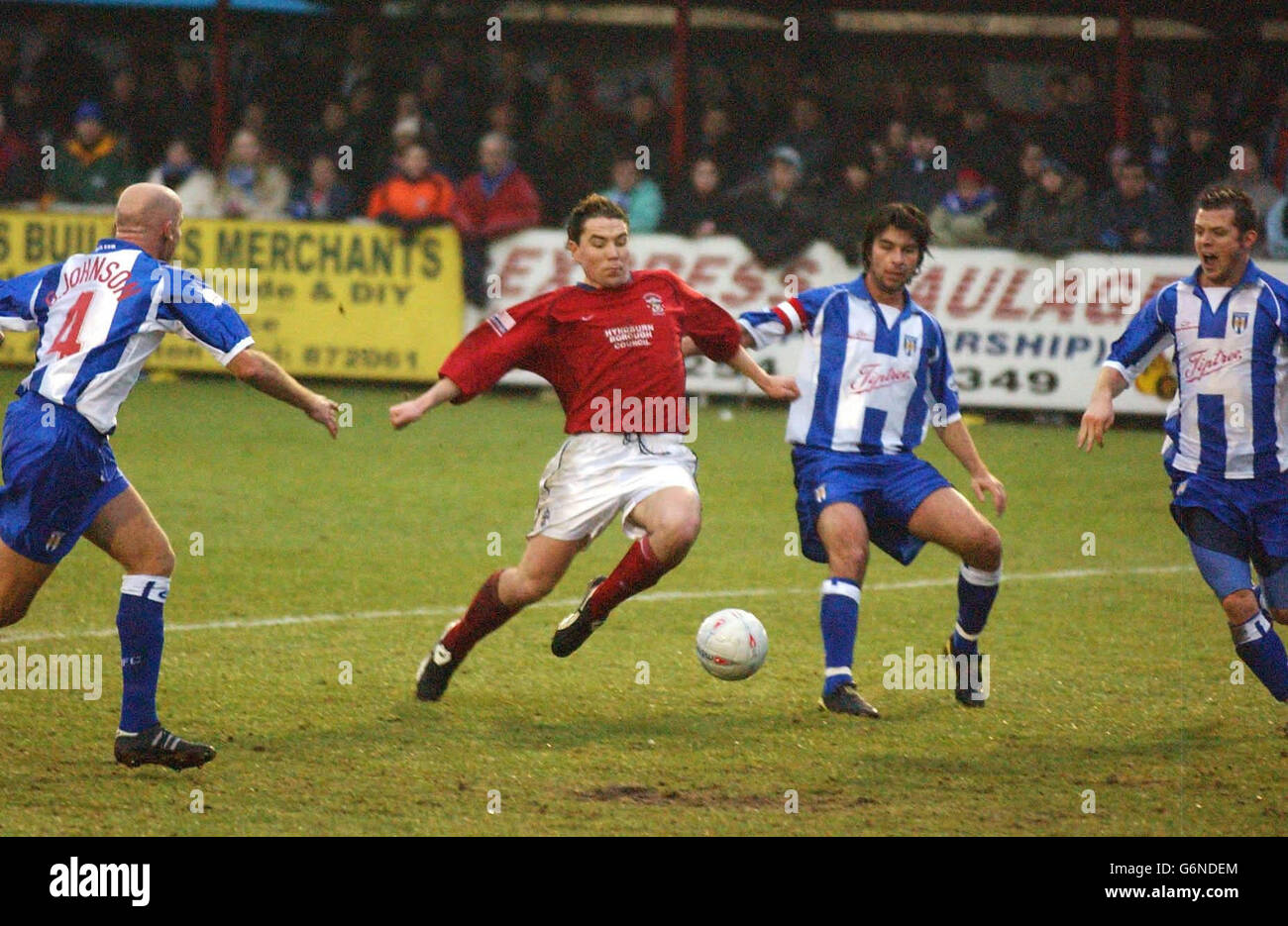 Rory Prendergast of Accrington Stanley (centre) splits the Colchester United defence during the FA Cup Third Round match at Interlink Express Stadium, Accrington. NO UNOFFICIAL CLUB WEBSITE USE. Stock Photo