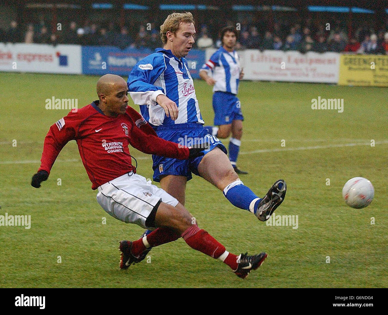 Lutel James (L) of Accrington Stanley beats Liam Chilvers of Colchester United to get his shot on goal during the FA Cup Third Round match at Interlink Express Stadium, Accrington. NO UNOFFICIAL CLUB WEBSITE USE. Stock Photo