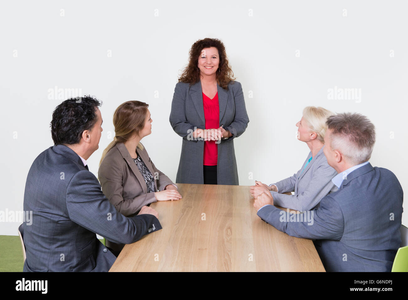 Happy business presentation in conference, business person standing and  coworkers sitting at the desk and listening Stock Photo