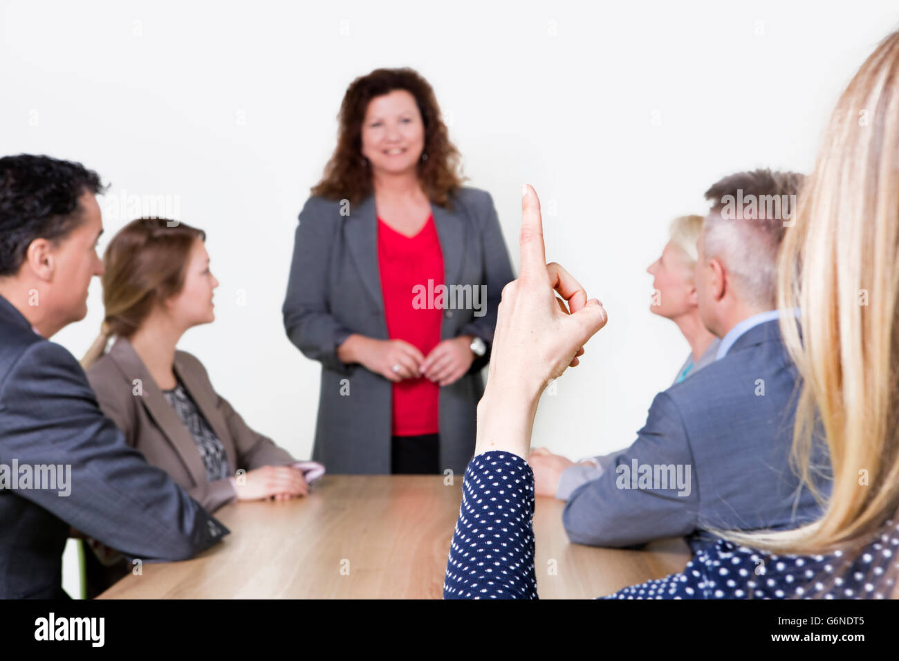 Business presentation in conference room, business person standing and  coworkers sitting at the desk and listening Stock Photo