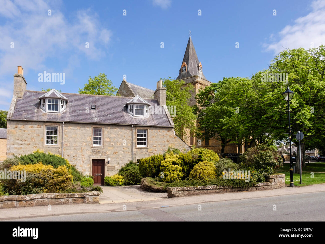 Stone cottage by 13th century Dornoch Cathedral in historic Royal Burgh of Dornoch, Sutherland, Highland Region, Scotland, UK, Britain Stock Photo