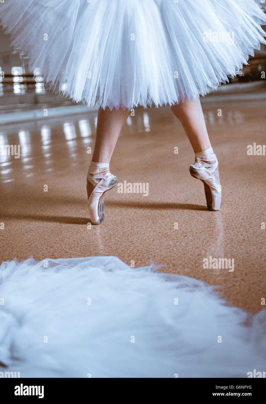 The close-up feet of young ballerina in pointe shoes Stock Photo