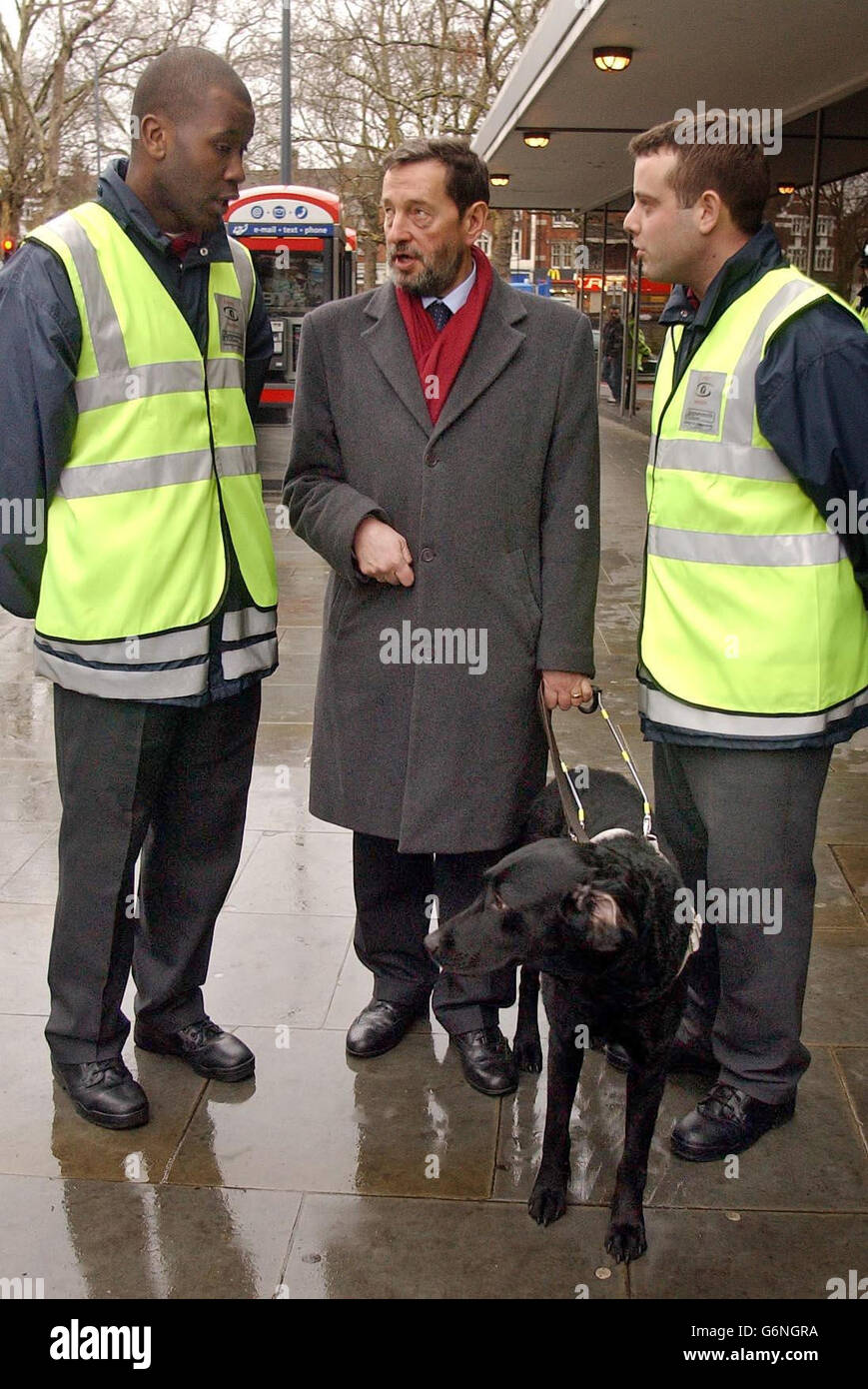 Home Secretary David Blunkett talks with Street Wardens Simeon Whatford (Right) and Sean Mullins (Left) in Shepherd's Bush, west London, as the Government launched new a new law to crack down on anti-social behaviour. Under new powers, police officers will be able to close down crack houses within 48 hours and keep them shut for up to six months and accredited private security guards will be able to stop cyclists for riding on the pavement. Stock Photo