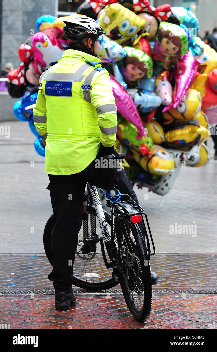 A police community support officer uses a police bicycle to patrol the ...