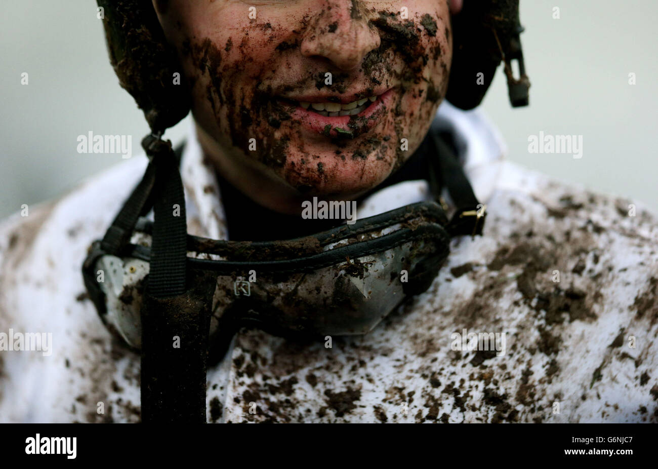 Jockey Alan Crowe is covered with mud in the parade ring after riding Cruinneas during the I.N.H. Stallion Owners European Breeders Fund Maiden Hurdle at Naas Racecourse, Naas. Stock Photo