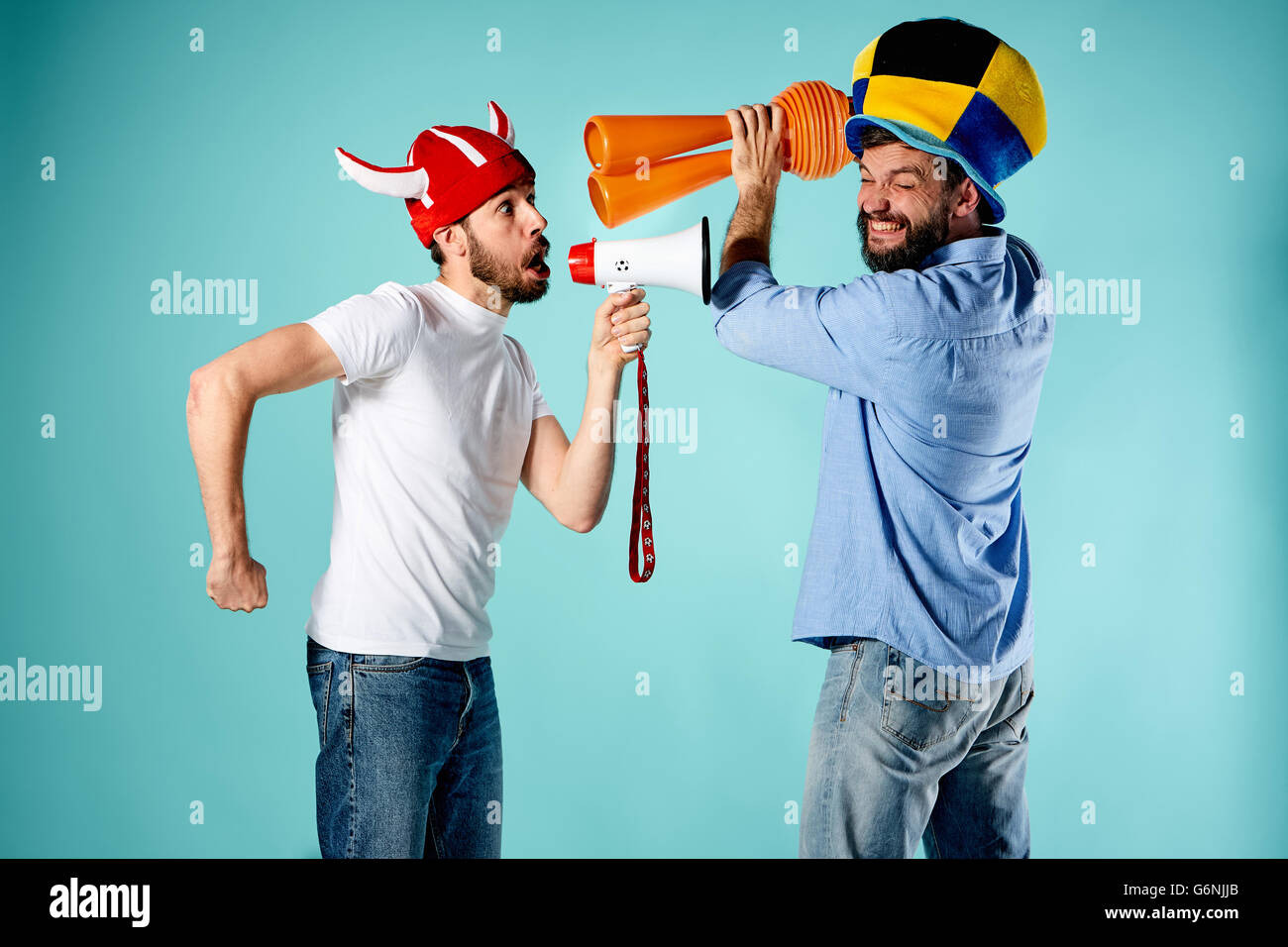 The two football fans with mouthpiece over blue Stock Photo Alamy