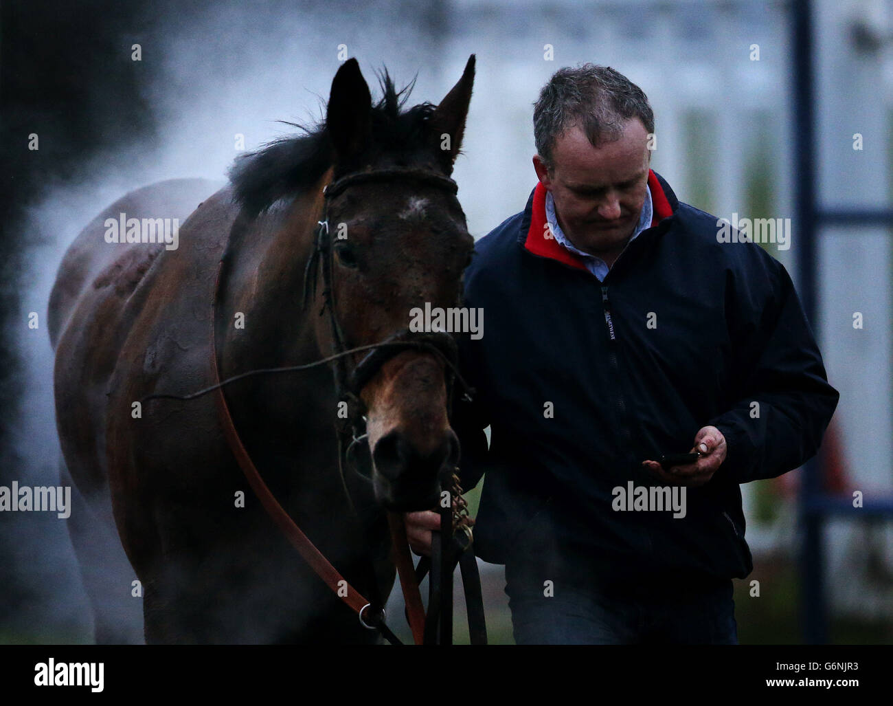 Trainer and owner John Clifford leads War of the Penneys from the parade ring after the Tipper Road (Pro/Am) Flat Race at Naas Racecourse, Naas. Stock Photo