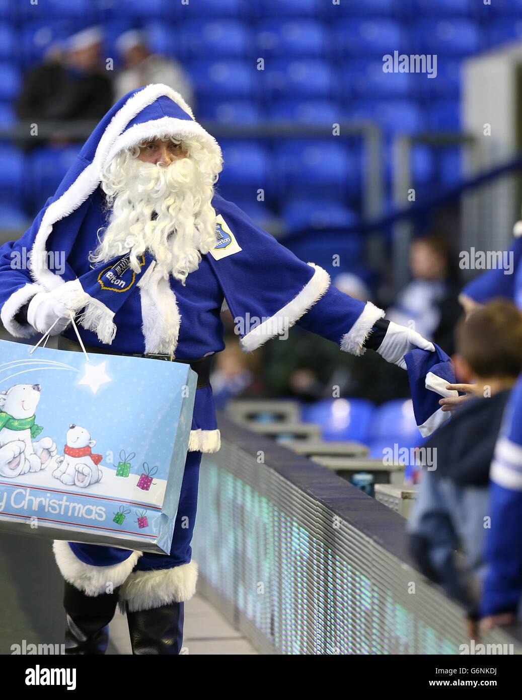 Santa hands out Christmas hats to fans pitchside at Goodison Park Stock ...