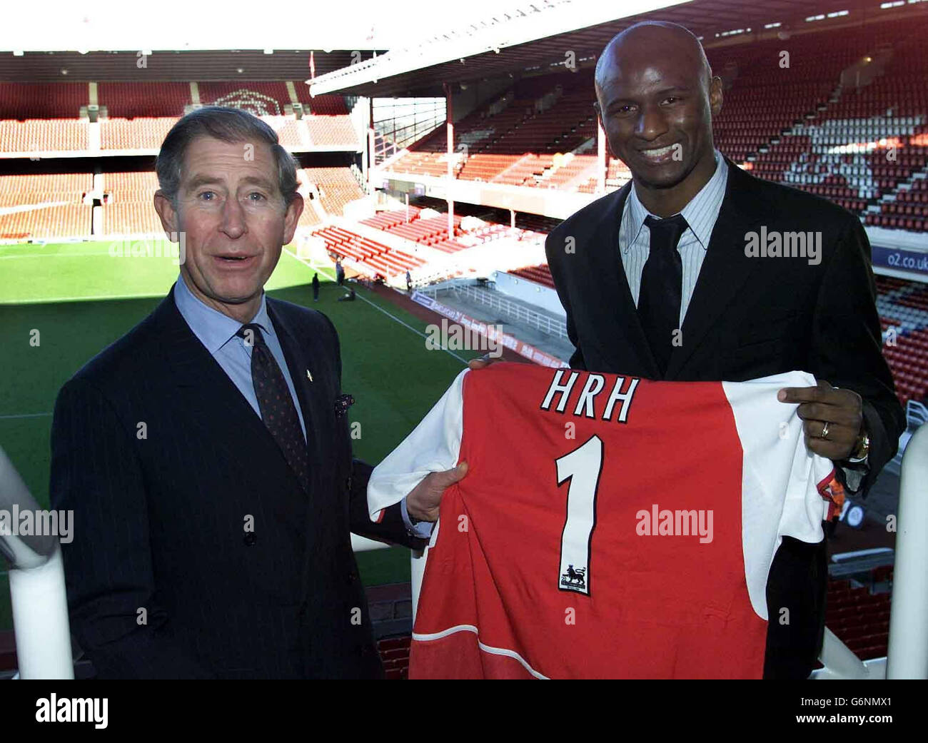 The Prince of Wales (left) is presented with an Arsenal shirt by club captain Patrick Vieira as he visits Arsenal FC's Highbury stadium in north London, to celebrate the sixth anniversary of The Prince's Trust Football Initiative. The Prince's Trust Football Initiative uses the appeal of football to motivate youngsters aged 16-25, and is funded by the FA Premier League, the Football Foundation and the Professional Footballers Association. Stock Photo