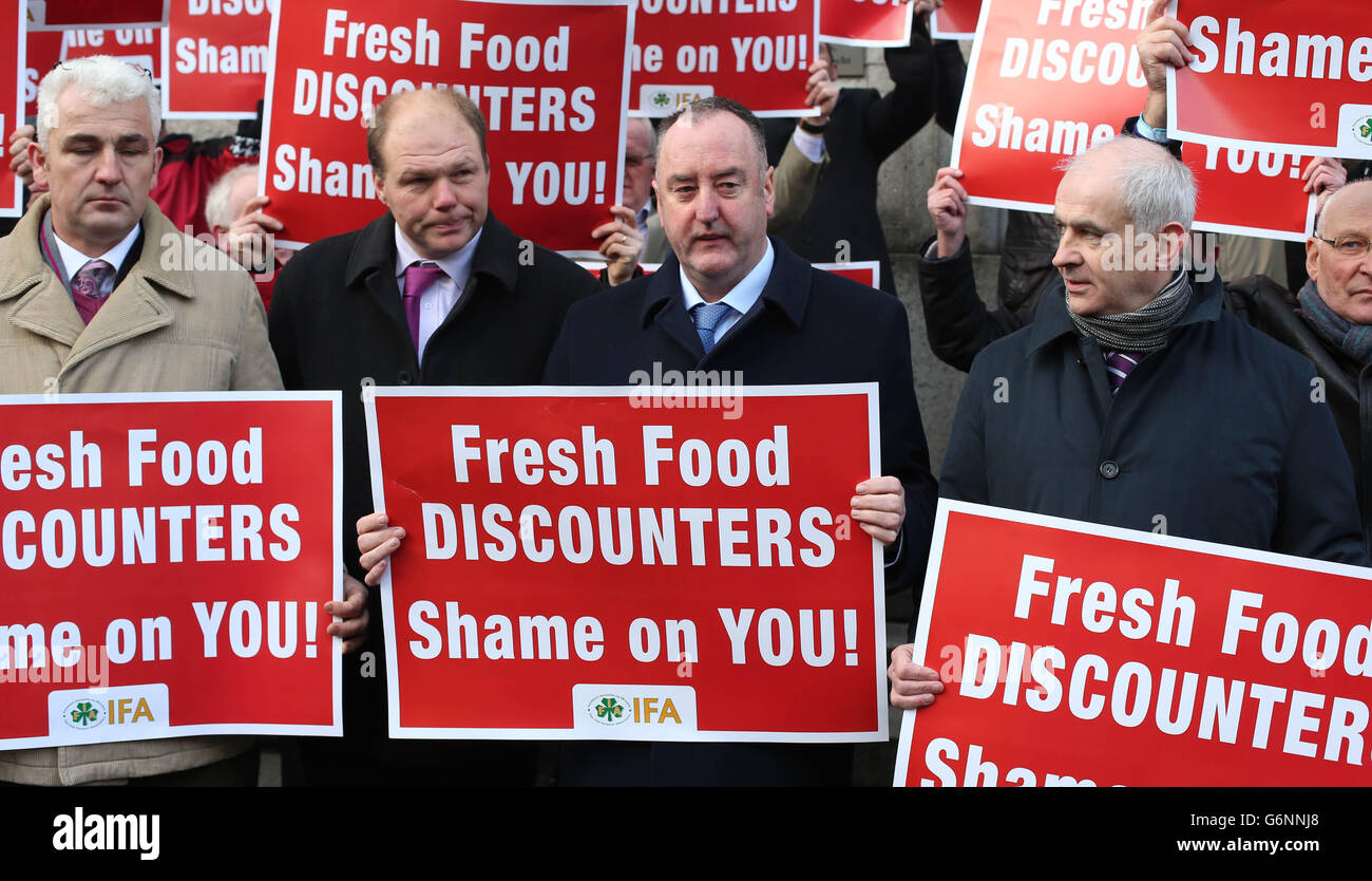 Irish Farmers Association (IFA) president John Bryan (centre) hands out
