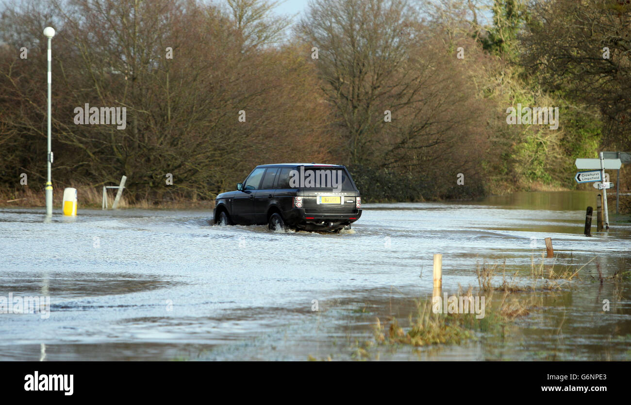 A 4x4 vehicle is driven through flood water near Lingfield in Surrey. Stock Photo
