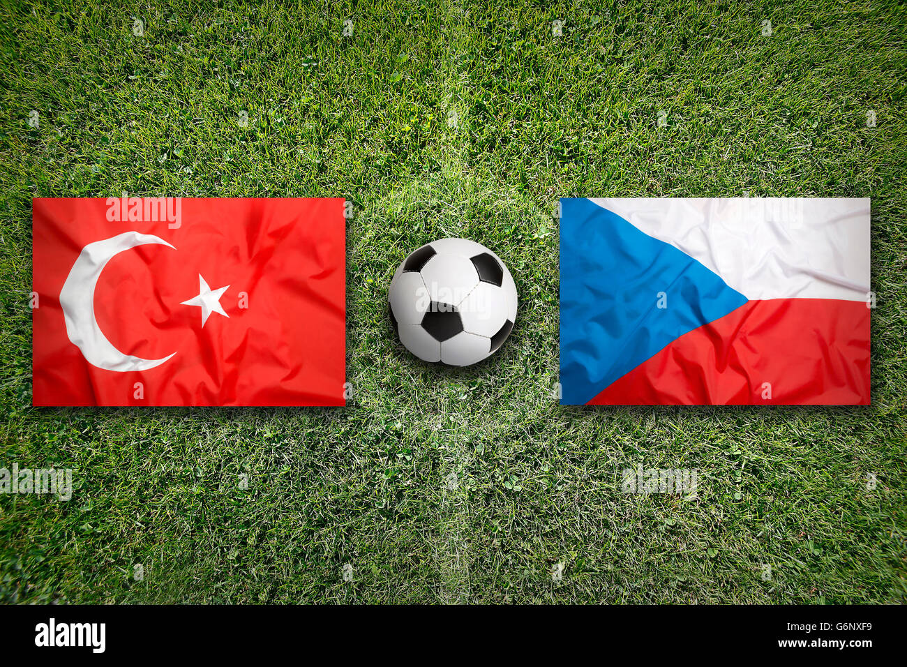 Turkey vs. Czech Republic flags on green soccer field Stock Photo