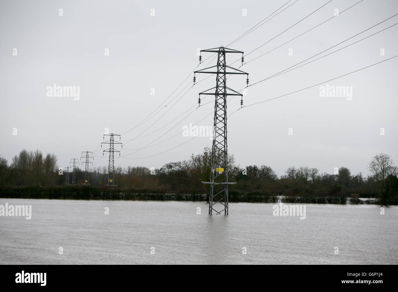 Electricity pylons are immersed in flood water near Shinfield, Berkshire, after the River Loddon burst its banks. Stock Photo