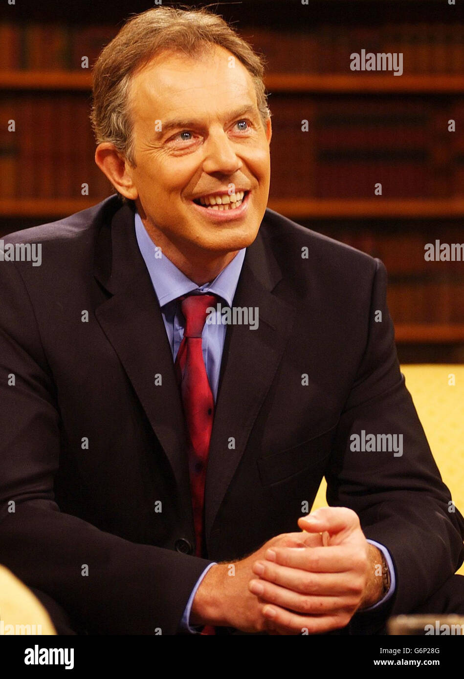 1 2 half length thinking smiling contemplative hands clasped tony blair