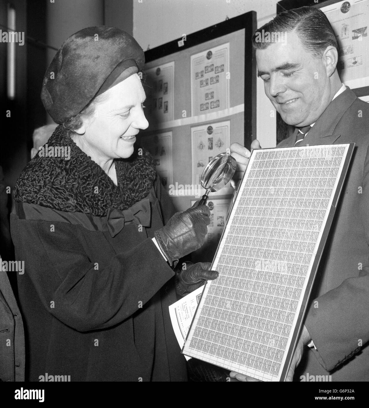 Miss Mervyn Pike, Assistant Postmaster General, examines a sheet of incorrectly perforated British halfpenny stamps at Stampex, the National Stamp Exhibition which she opened at the Central Hall, Westminster, London. Stock Photo