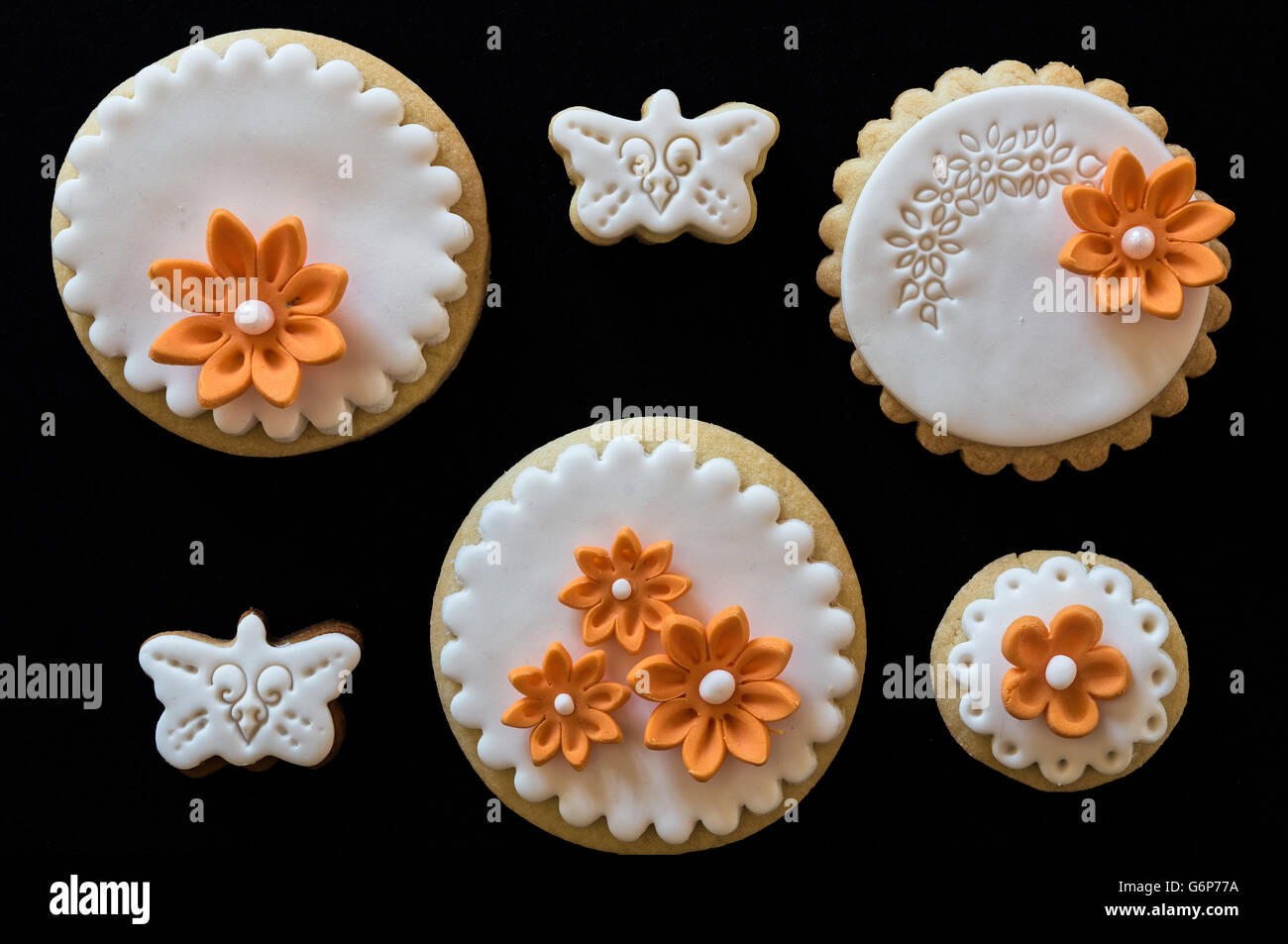 Homemade white butter cookies, decorated with orange flowers Stock Photo