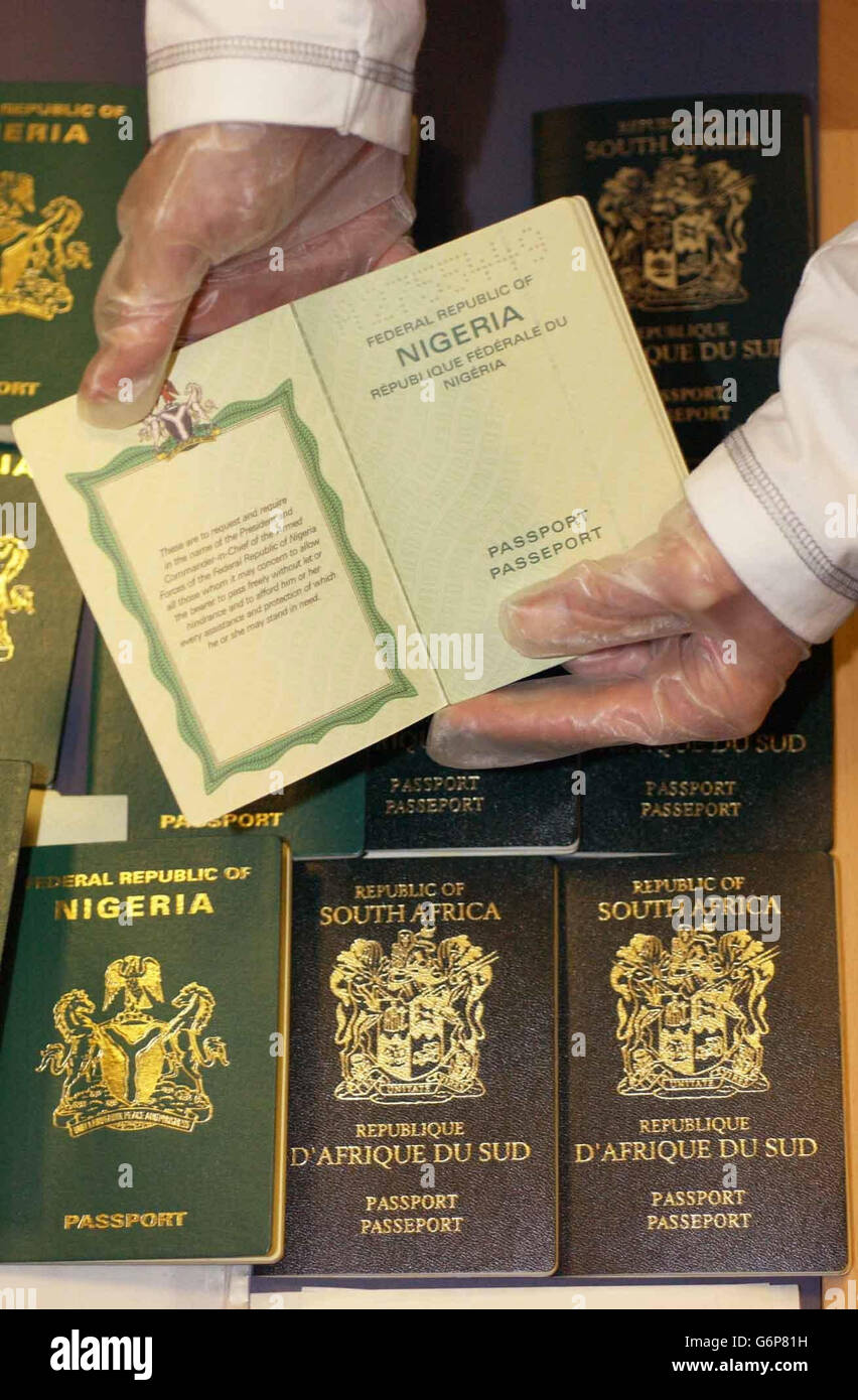Some of the passports and documents seized during a raid by police in Camberwell, south east London. A 27-year-old Nigerian, who had been refused asylum and was living on a false identity, was arrested by detectives who found 200 passports, driving licences, birth certificates and official stamps at a terrace house in Camberwell. Stock Photo