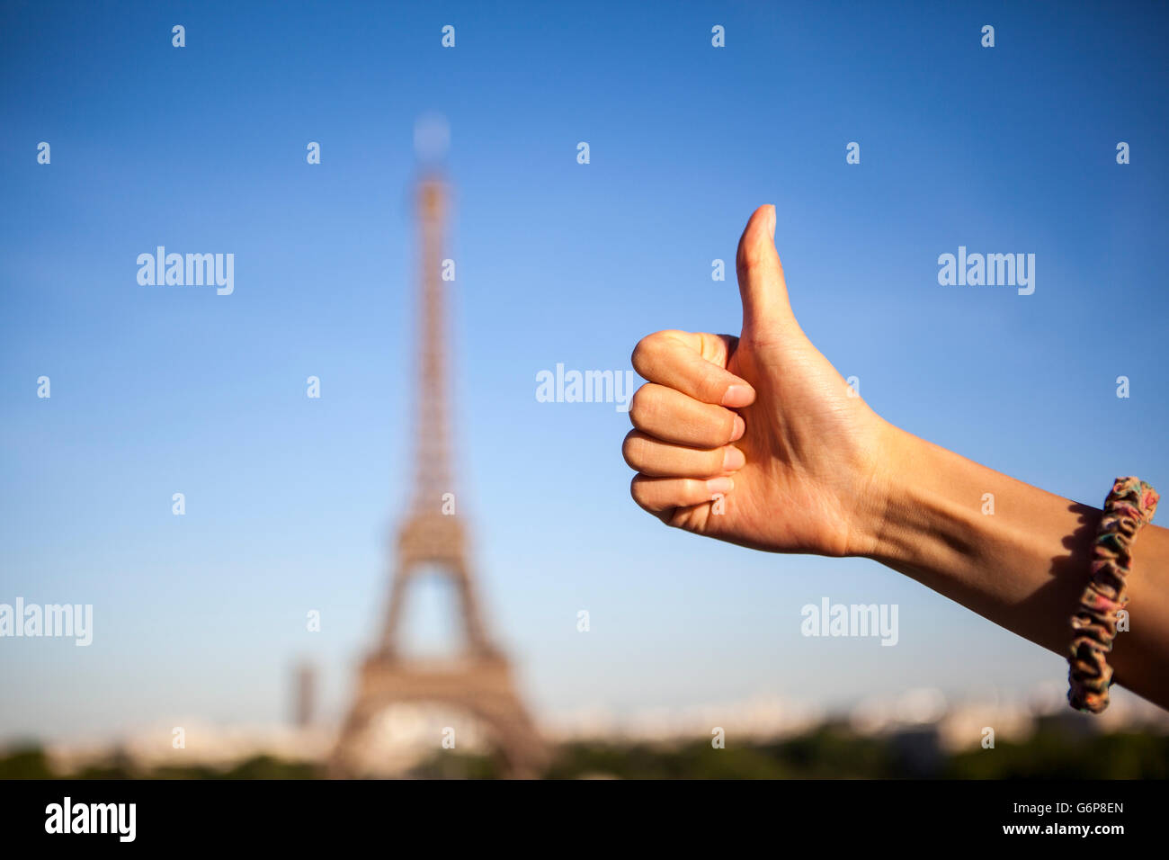 thumb up on Eiffel Tower, Paris Stock Photo