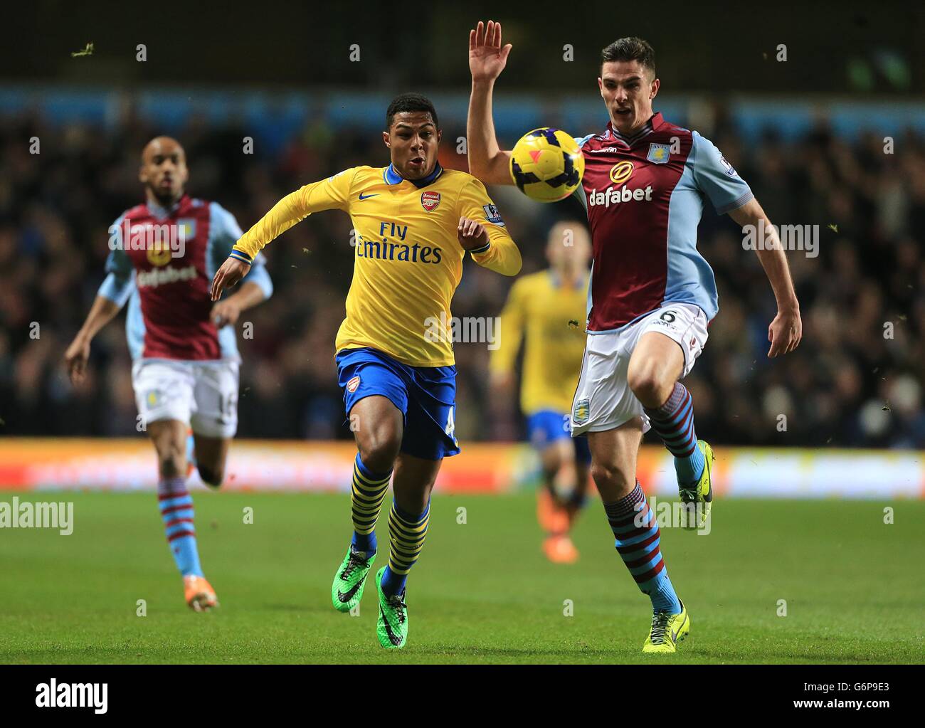 Soccer - Barclays Premier League - Aston Villa v Arsenal - Villa Park. Aston Villa's Ciaran Clark (right) and Arsenal's Serge Gnabry battle for the ball Stock Photo