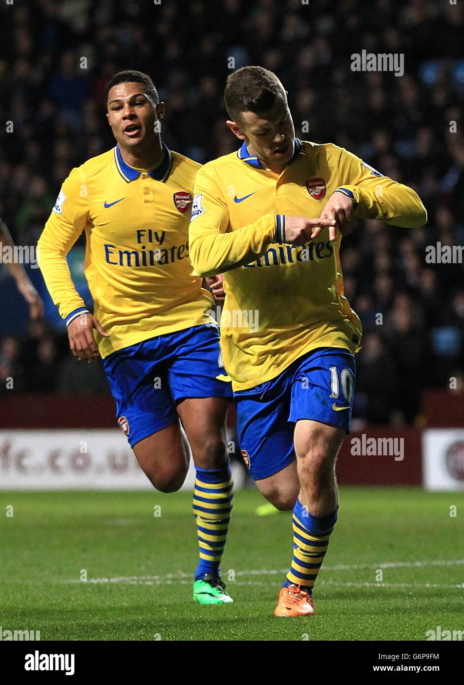 Arsenal's Jack Wilshere (right) celebrates scoring his teams opening goal with teammate Serge Gnabry Stock Photo