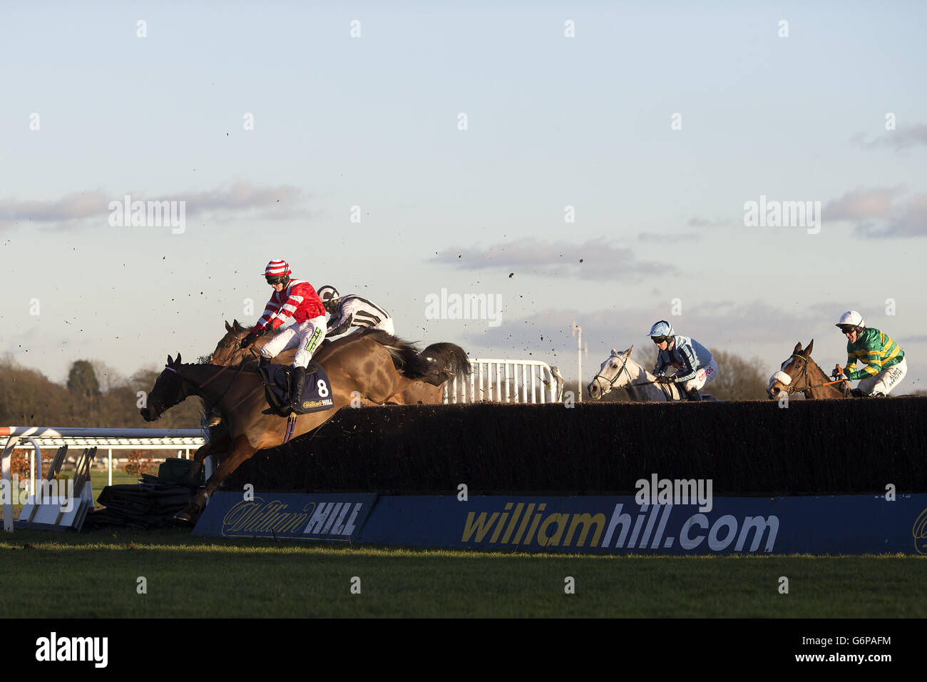 Jockey Tom Cannon on On Trend (left) during the William Hill - Bet On The Move Handicap Chase Stock Photo
