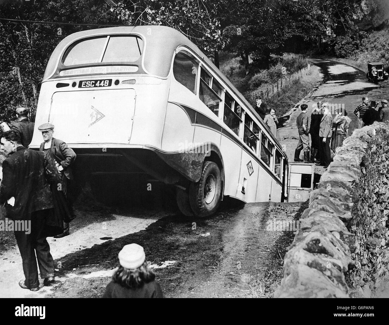 A bus which was crossing Millburn bridge, near Duns, Berwickshire, when the middle of the bridge gave way. The bus plunged into this hole and stayed suspended over the heavily swollen stream. Eleven people were injured. Scenes of desolation were left in North Northumberland and the Border country as floods which had inundated hundreds of square miles, sweeping away five railway bridges and at least four road bridges causing landslides and isolating villages, began to recede. Stock Photo