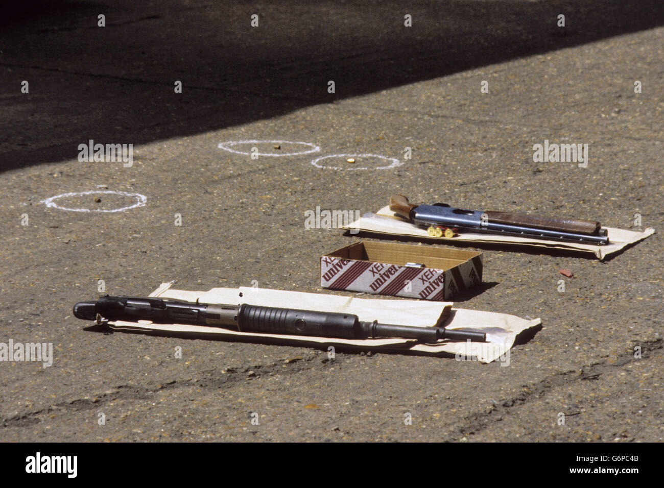 Two pump-action shotguns and three spent cartridge shells marking the site of an attempted robbery at an attempted robbery at an abattoir in Garland Road, Shooter's Hill, London, in which police shot dead two men. Stock Photo