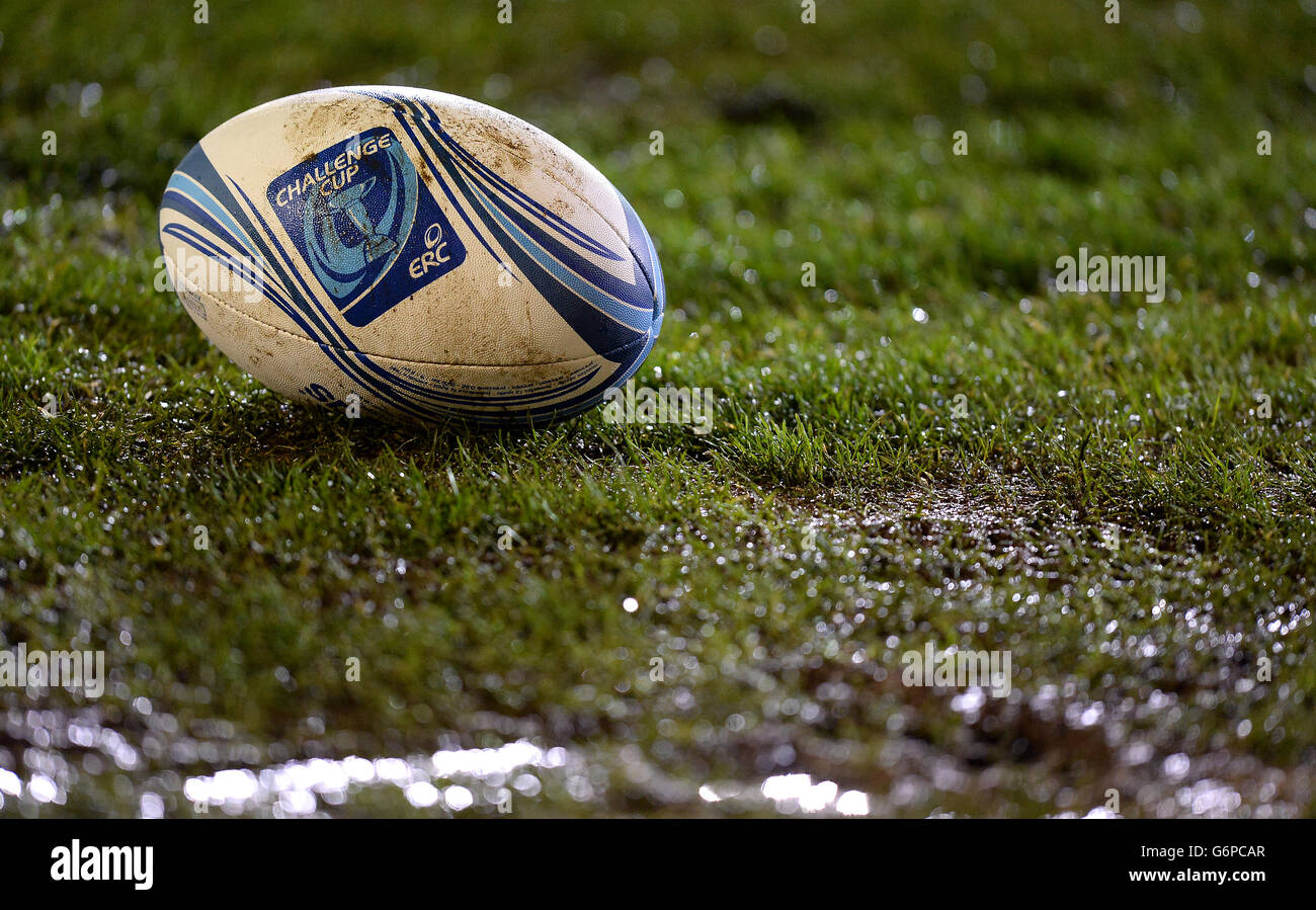 General view of an official Adidas Amlin Challange Cup match rugby ball  lying on the muddy pitch Stock Photo - Alamy