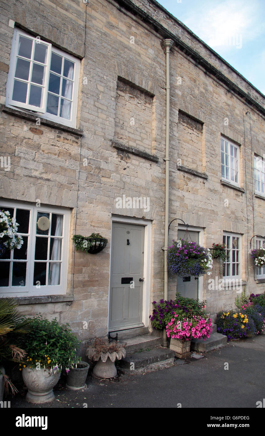 Stone cottages with bricked up upper floor windows Cirencester
