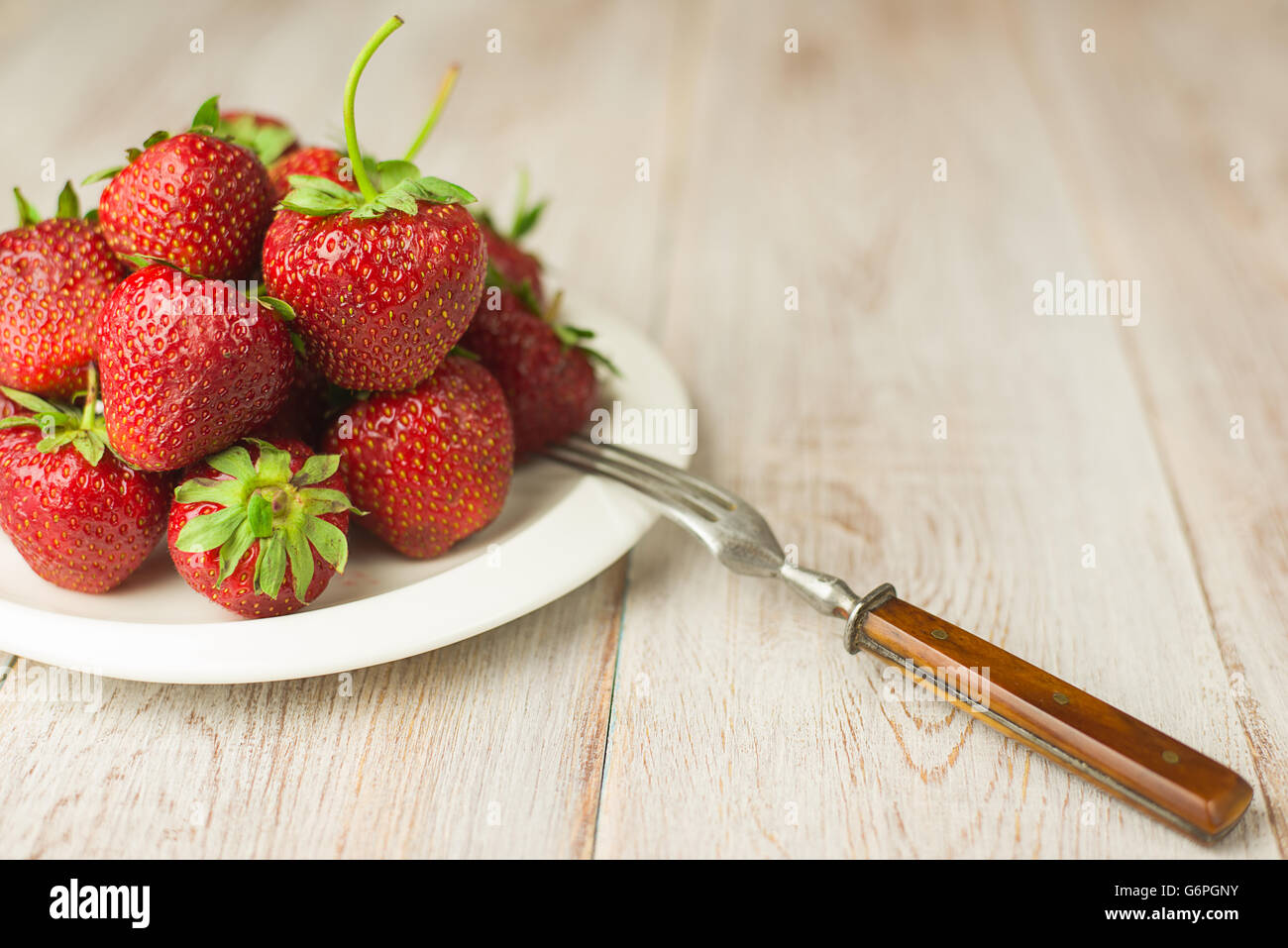 Ripe red strawberries on a white plate Stock Photo - Alamy