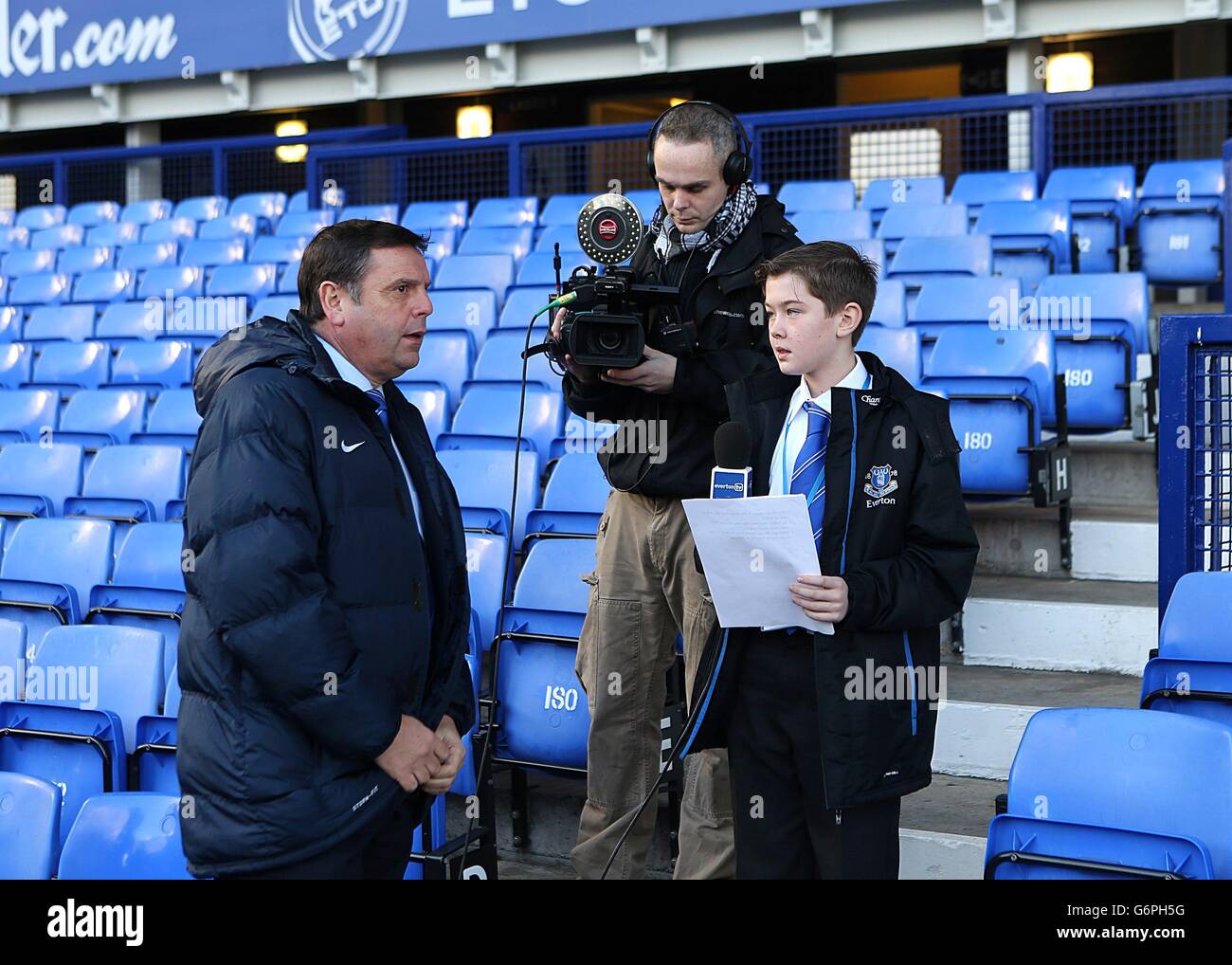 Soccer - Barclays Premier League - Everton v Norwich City - Goodison Park. A mini Everton TV reporter interviews Graeme Sharp in the stands Stock Photo