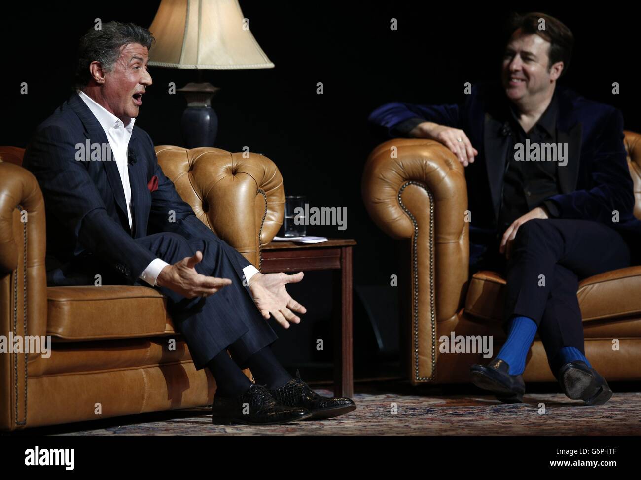 Sylvester Stallone appears onstage with interviewer Jonathan Ross at the London Palladium in Central London for An Evening with Sylvester Stallone on January 11, 2014. Stock Photo