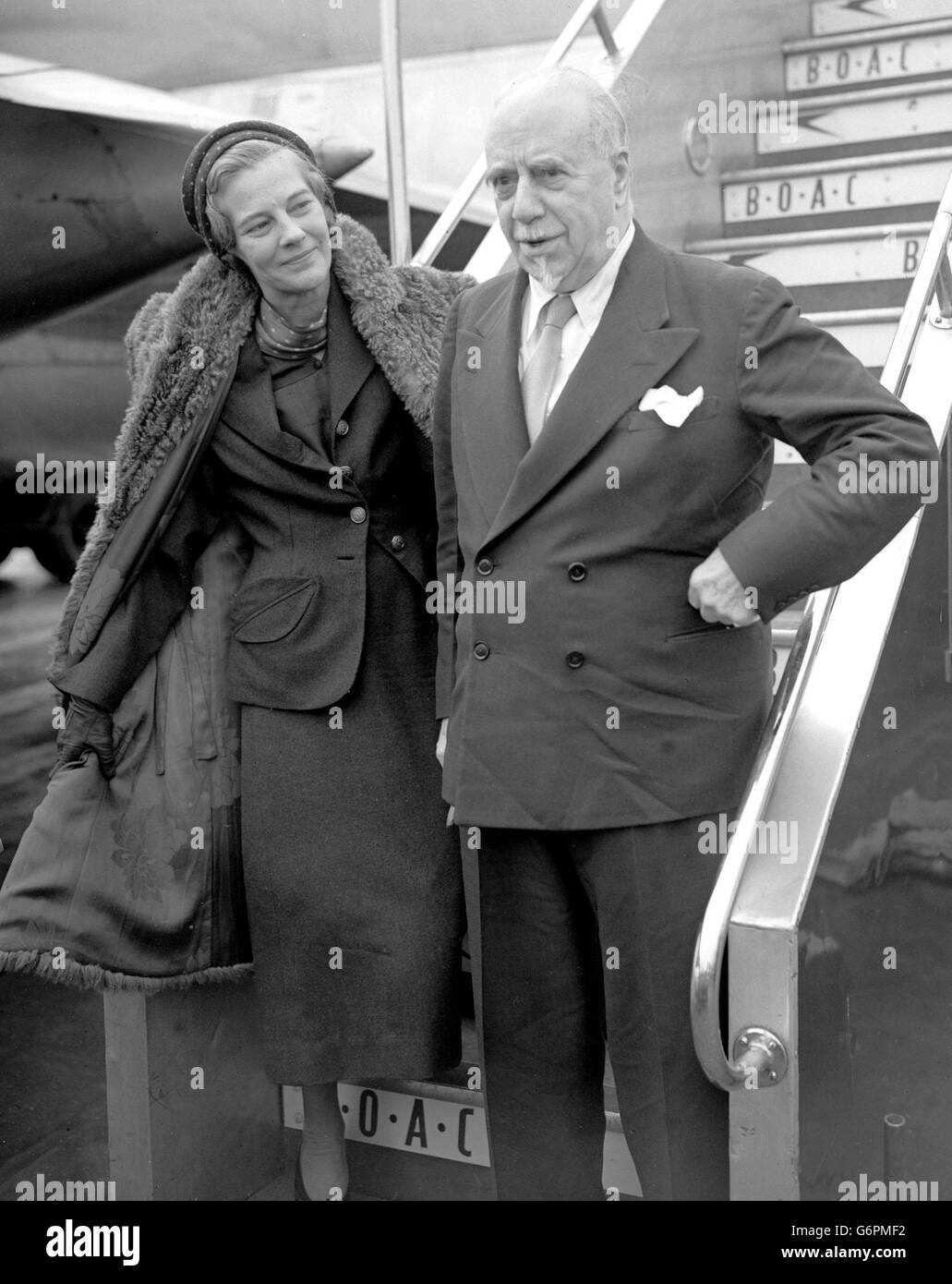 Arriving at London Airport, by BOAC Monarch flight from New York are Sir Thomas and Lady Beecham. They have been in the USA on a six-week holiday which Sir Thomas twice interrupted to conduct concerts, one in Balitmore and the other in Washington. Stock Photo