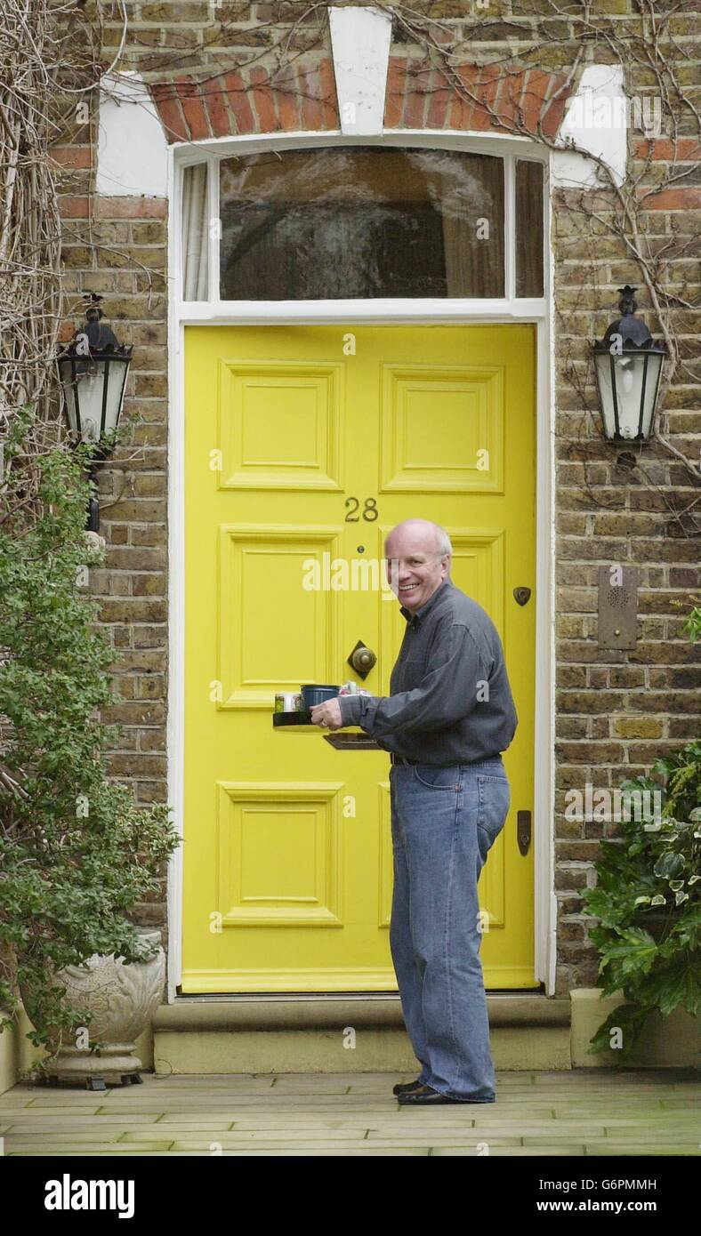 The former Director General of the BBC, Greg Dyke, carries a tray of tea made for journalists, back into his home in Twickenham, south west London, the day after he resigned from his post following criticism of the BBC in the Hutton report. Stock Photo