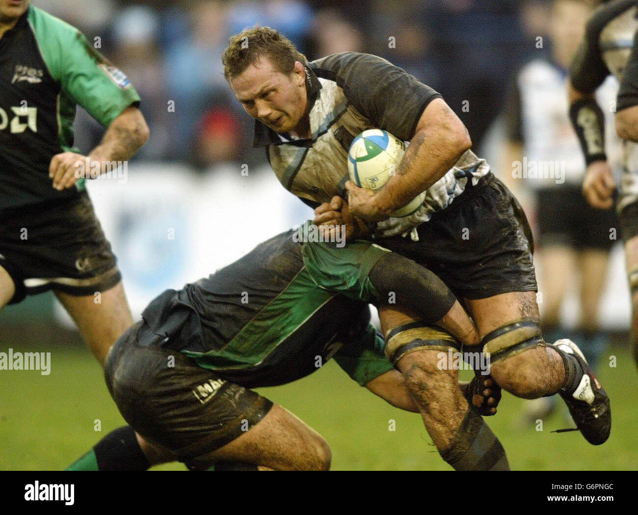 Cardiff's Nathan Thomas surges into the tackle of Sale's Braam van Straaten during today's Heineken Cup Pool 3 match at Cardiff Arms Park, Cardiff, Saturday 31st January 2004. Stock Photo