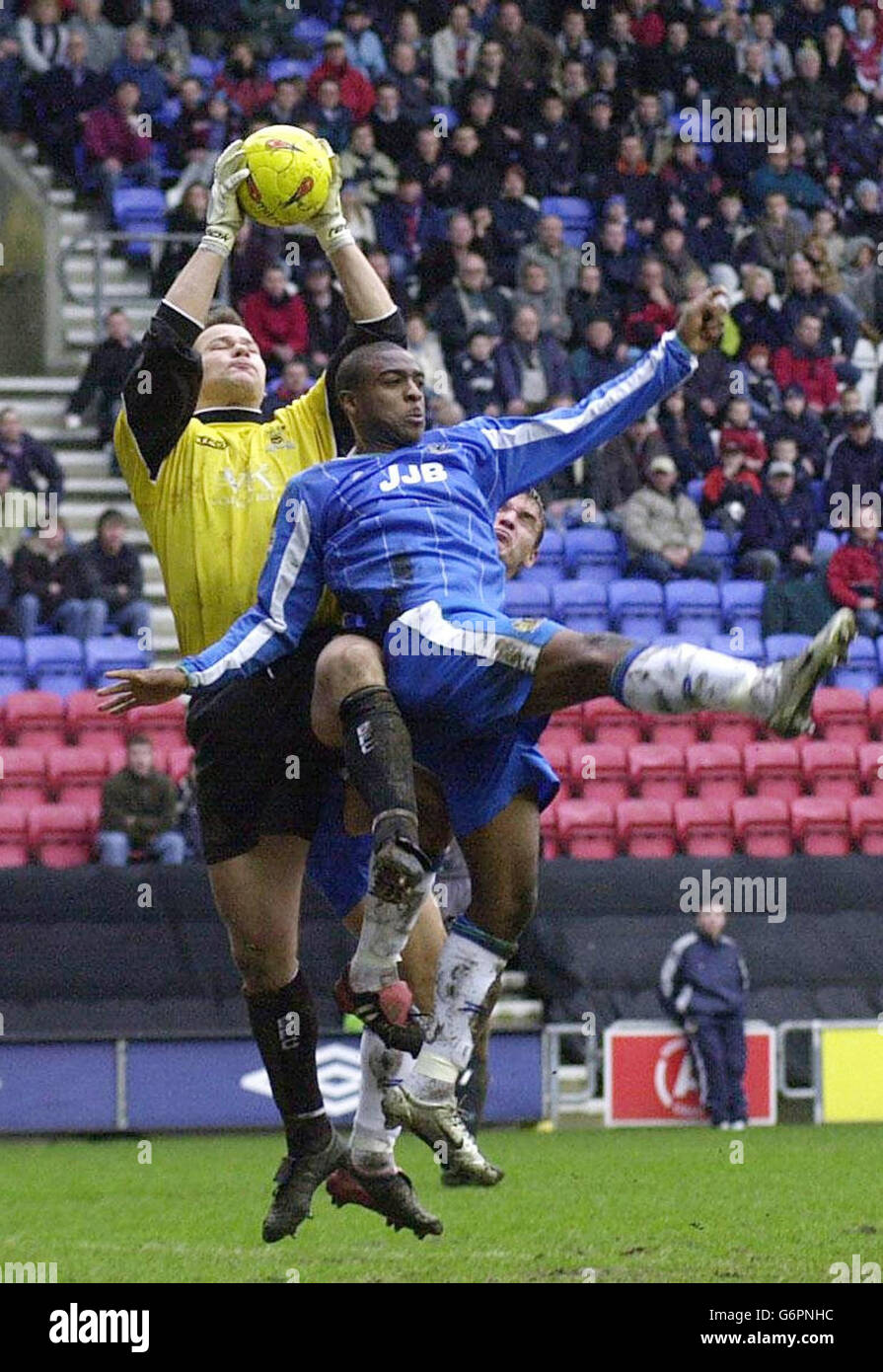 Burnley's Brian Jensen saves from Wigan's Nathan Ellington during their Nationwide Division One match at Wigan's JJB Stadium. NO UNOFFICIAL CLUB WEBSITE USE. Stock Photo