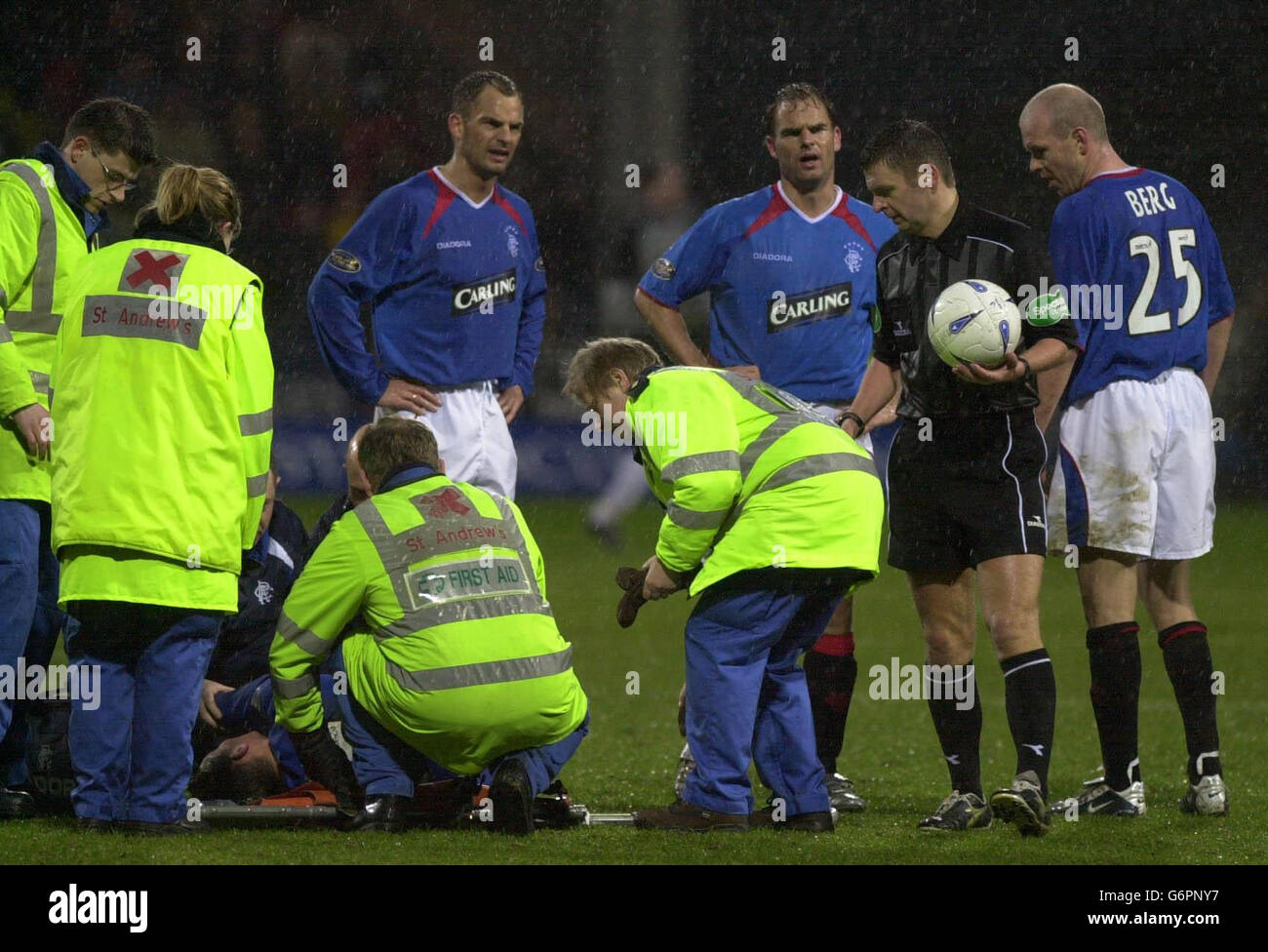 : Rangers' Peter Lovenkrands lies on the ground injured while team-mates Frank de Boer and Ronald de Boer look on during the Bank of Scotland Scottish Premiership match against Partick Thistle at Partick's Firhill Park ground in Glasgow. Stock Photo