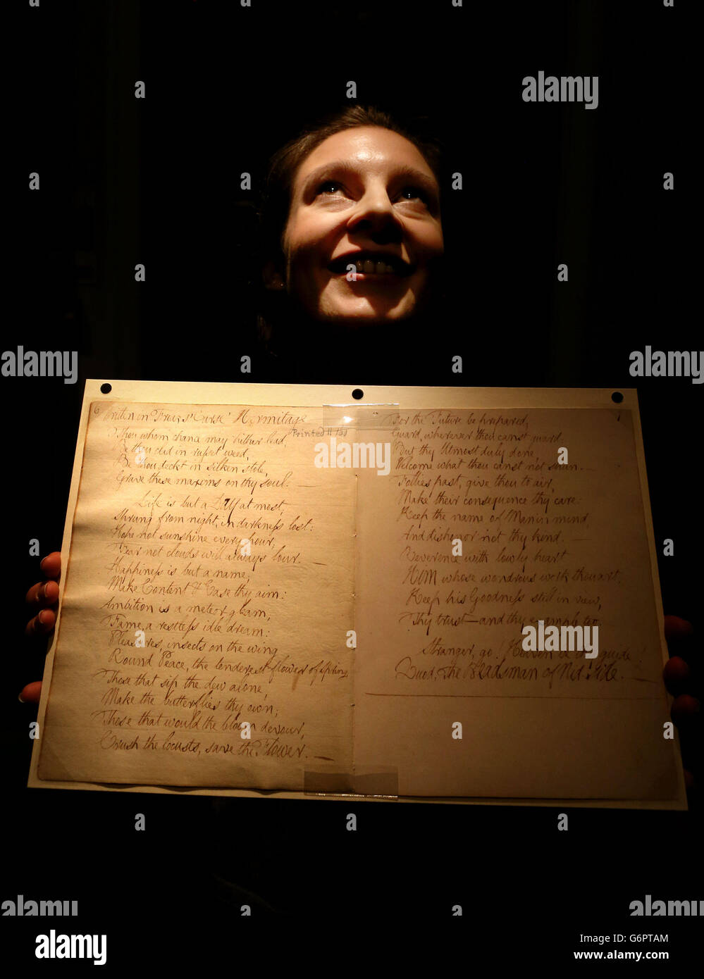 Ciara McDermott holds a handwritten poem by Robert Burns before it goes on display at the National Library of Scotland visitor centre in Edinburgh. Stock Photo