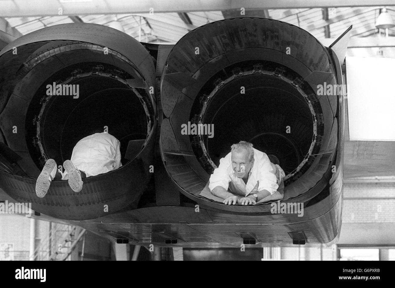 Richard Schofield (L), of Fleet, Hampshire, and workmate Fred Appleby, of Colnbrook, Berkshire, working on one of the Anglo-French Concorde supersonic airliner's at London Heathrow Airport. Stock Photo
