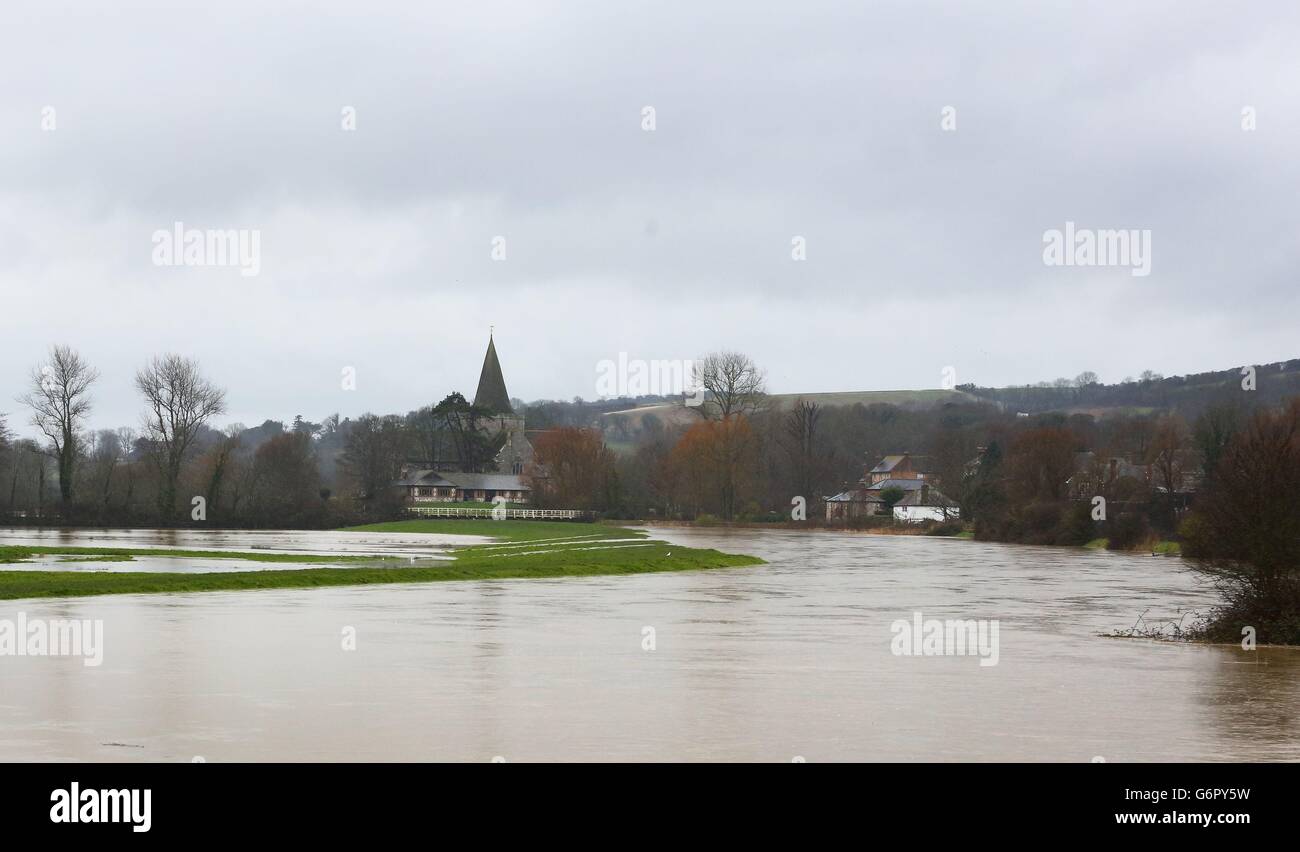 The swollen Cuckmere River heads towards Alfriston, East Sussex, as more heavy rain sweeps across the country. Stock Photo