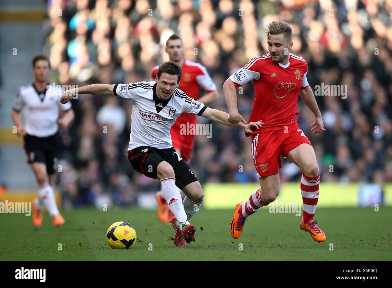 Fulham's Sascha Riether (left) and Southampton's Luke Shaw battles for possession of the ball during the Barclays Premier League match at Craven Cottage, London. Stock Photo