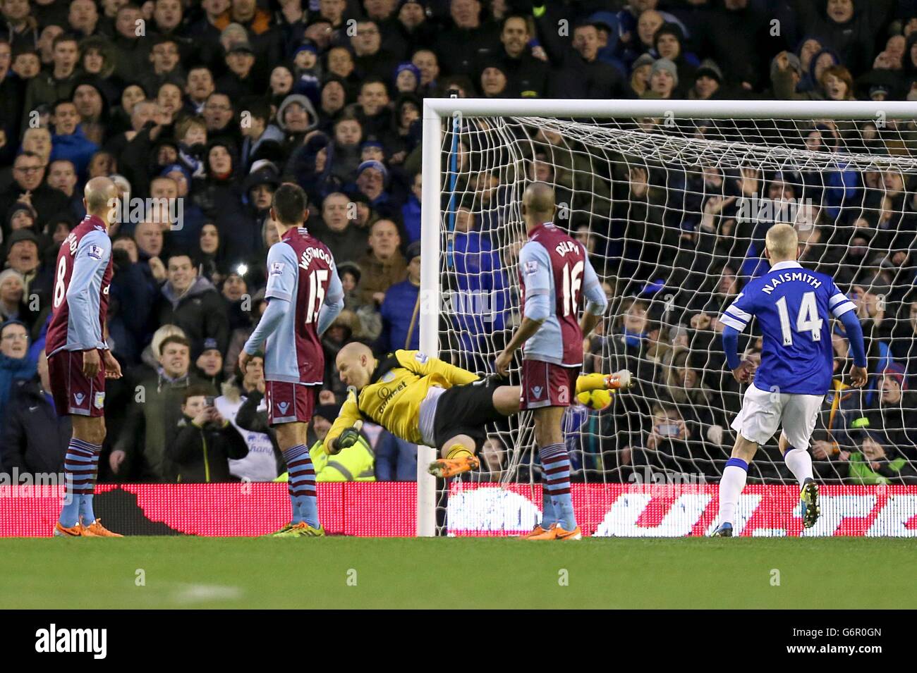 Players turn to watch Aston Villa goalkeeper Bradley Guzan (behind) fail to stop Everton's Kevin Mirallas (not in picture) from scoring their second goal of the game Stock Photo