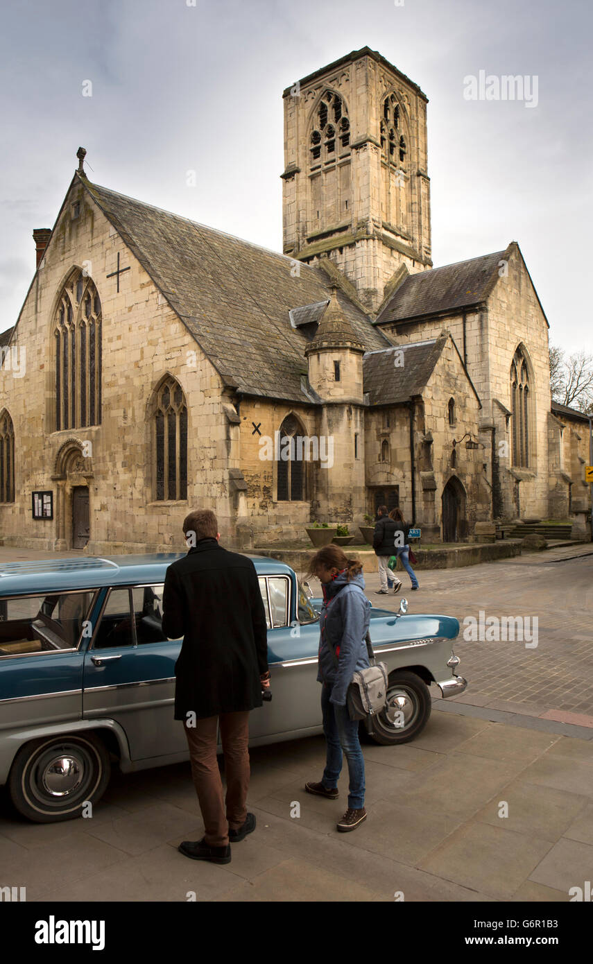 UK, Gloucestershire, Gloucester, Southgate Street, couple admiring 1960s Vauxhall Victor car at St Mary de Crypt Church Stock Photo
