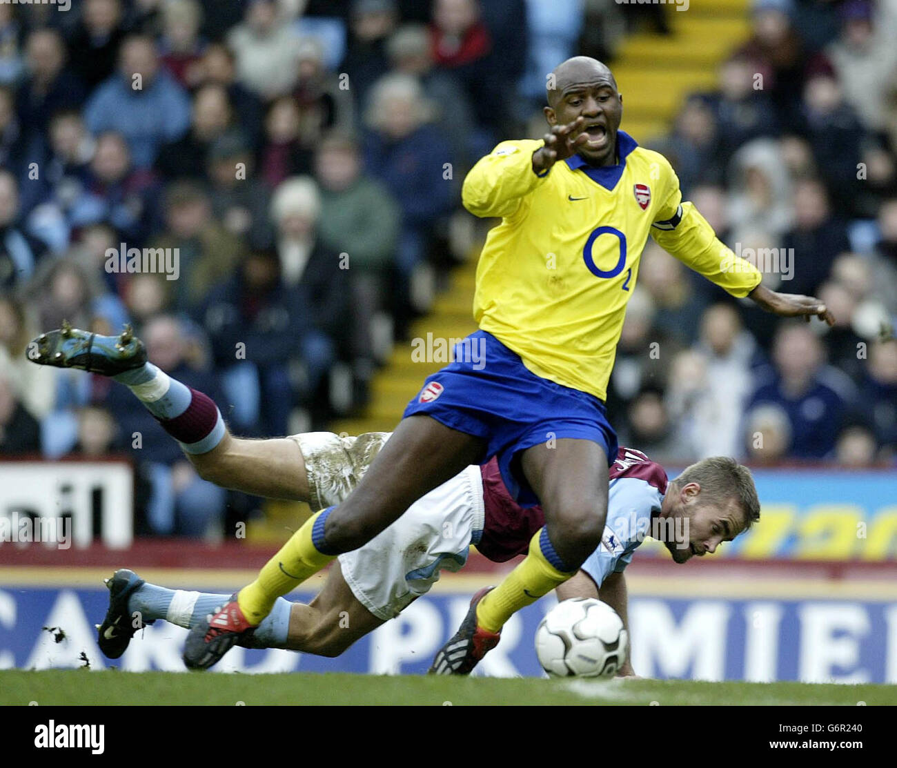 Arsenal's Patrick Vieira goes down on the edge of the penalty area after a challenge from Aston Villa defender Olof Mellberg during the FA Barclaycard Premiership match at Villa Park, Birmingham. Stock Photo