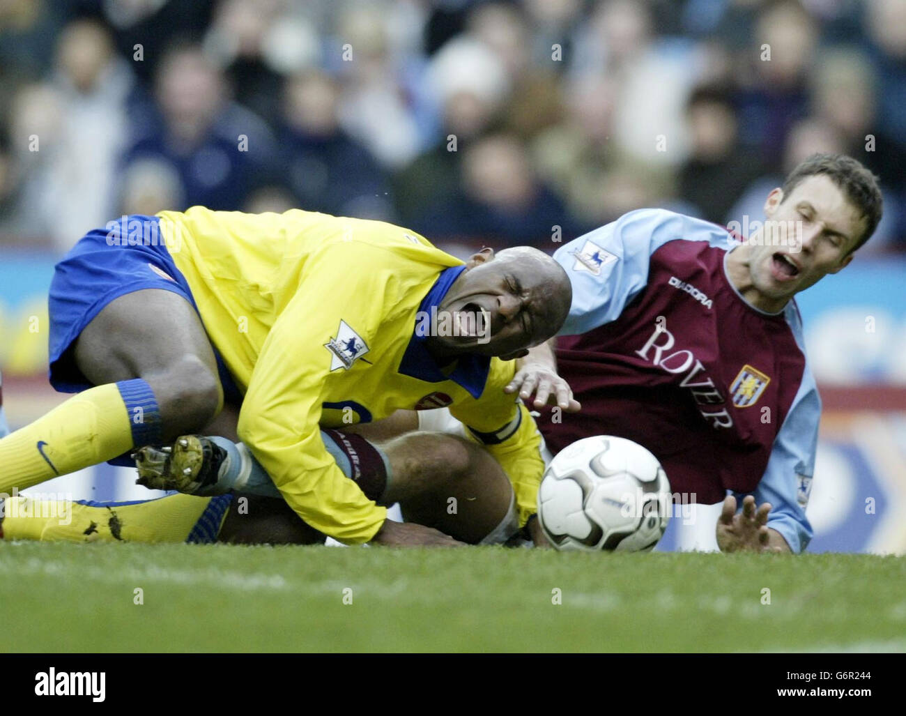 Arsenal's Patrick Vieira (left) goes down on the edge of the penalty area after a challenge from Aston Villa defender Ronnie Johnsen during the FA Barclaycard Premiership match at Villa Park, Birmingham. Stock Photo