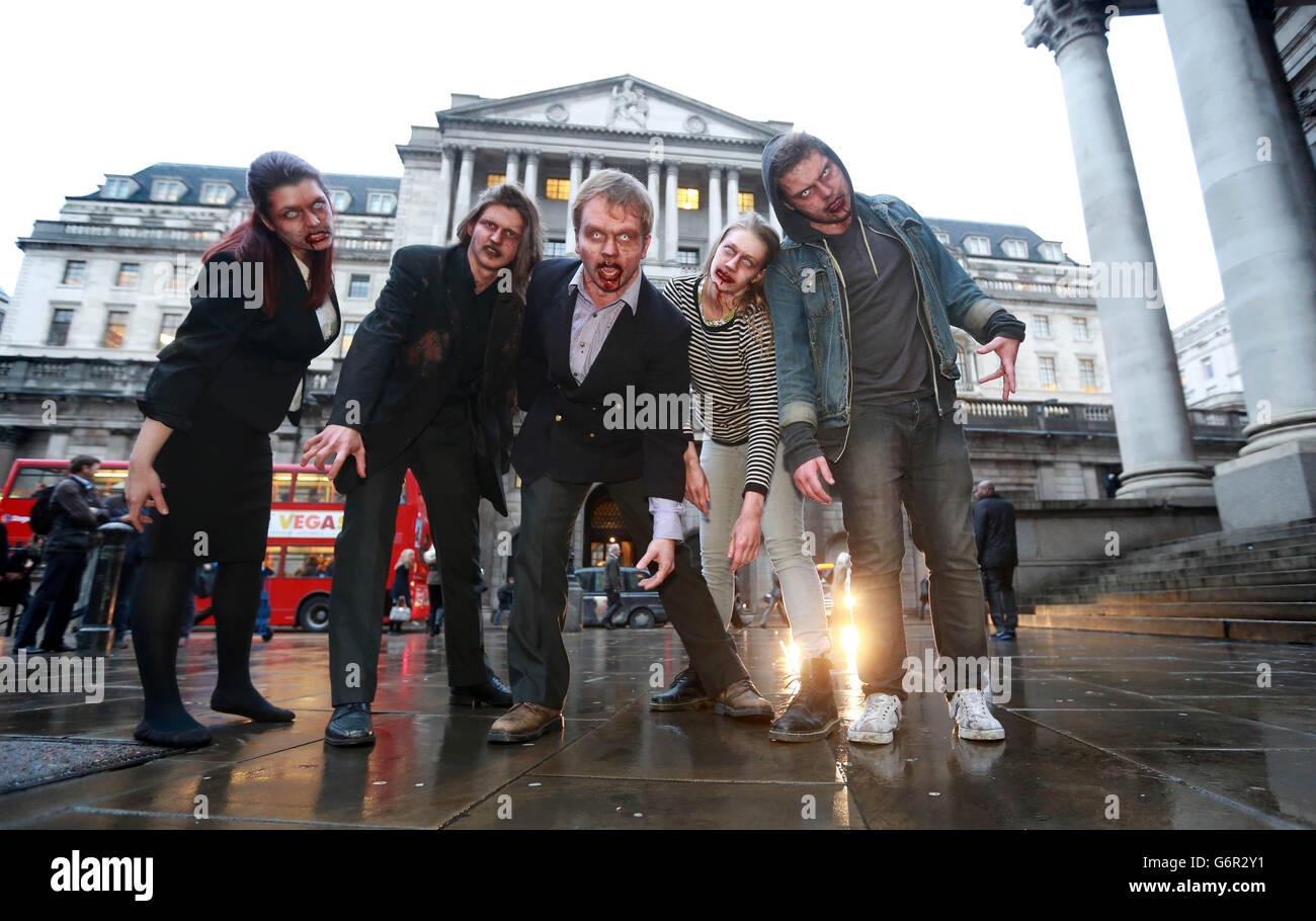Actors dressed as zombies outside the Bank of England in London as peer-to-peer lender RateSetter highlights the issue of 'zombie' savings accounts with 'lifeless returns'. Stock Photo
