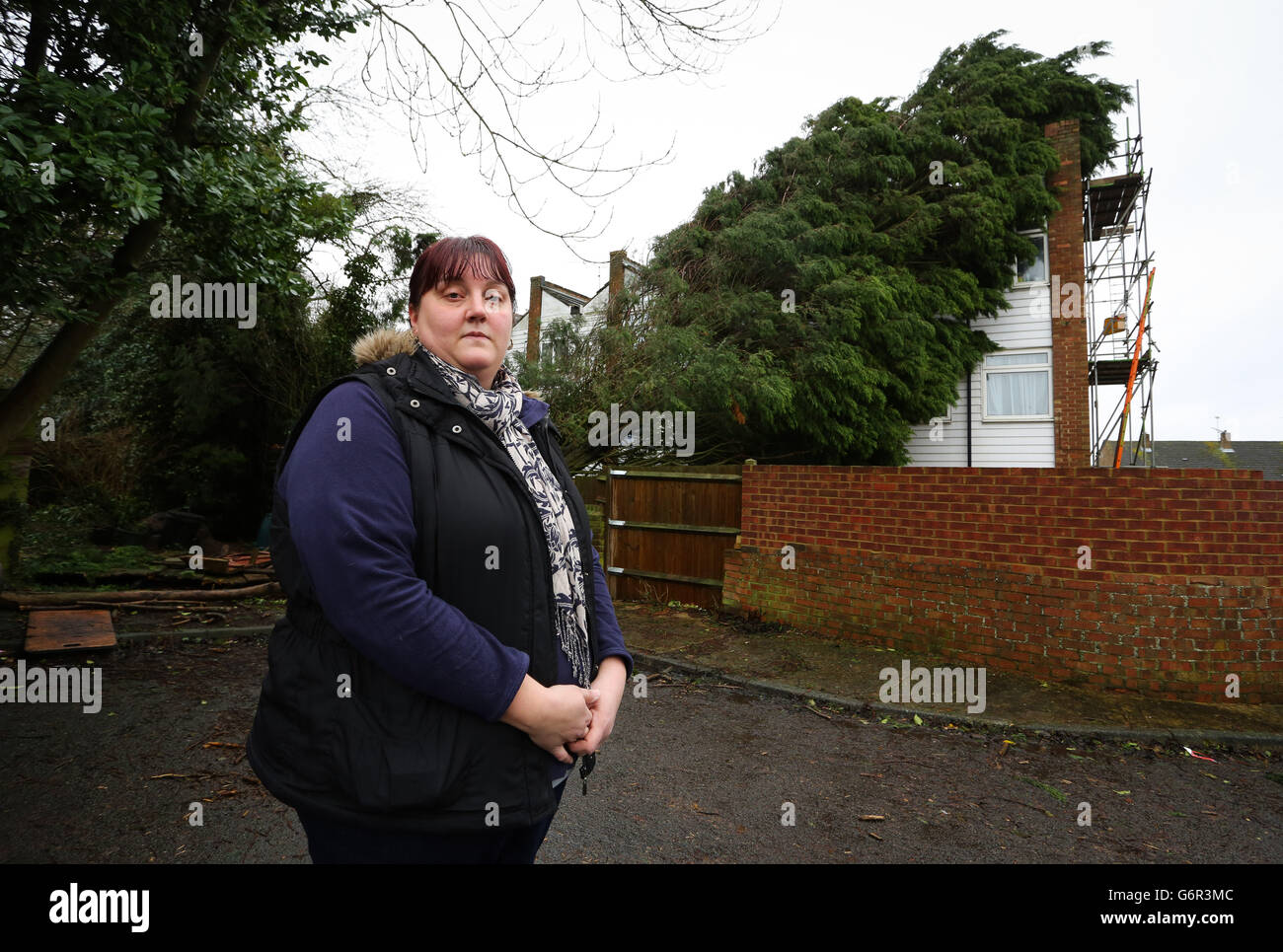 Heidi Brett, outside her home in Walderslade, Kent, where a leylandii tree which fell onto her house on Christmas eve, has still not been moved following a dispute over who is responsible for it. Stock Photo