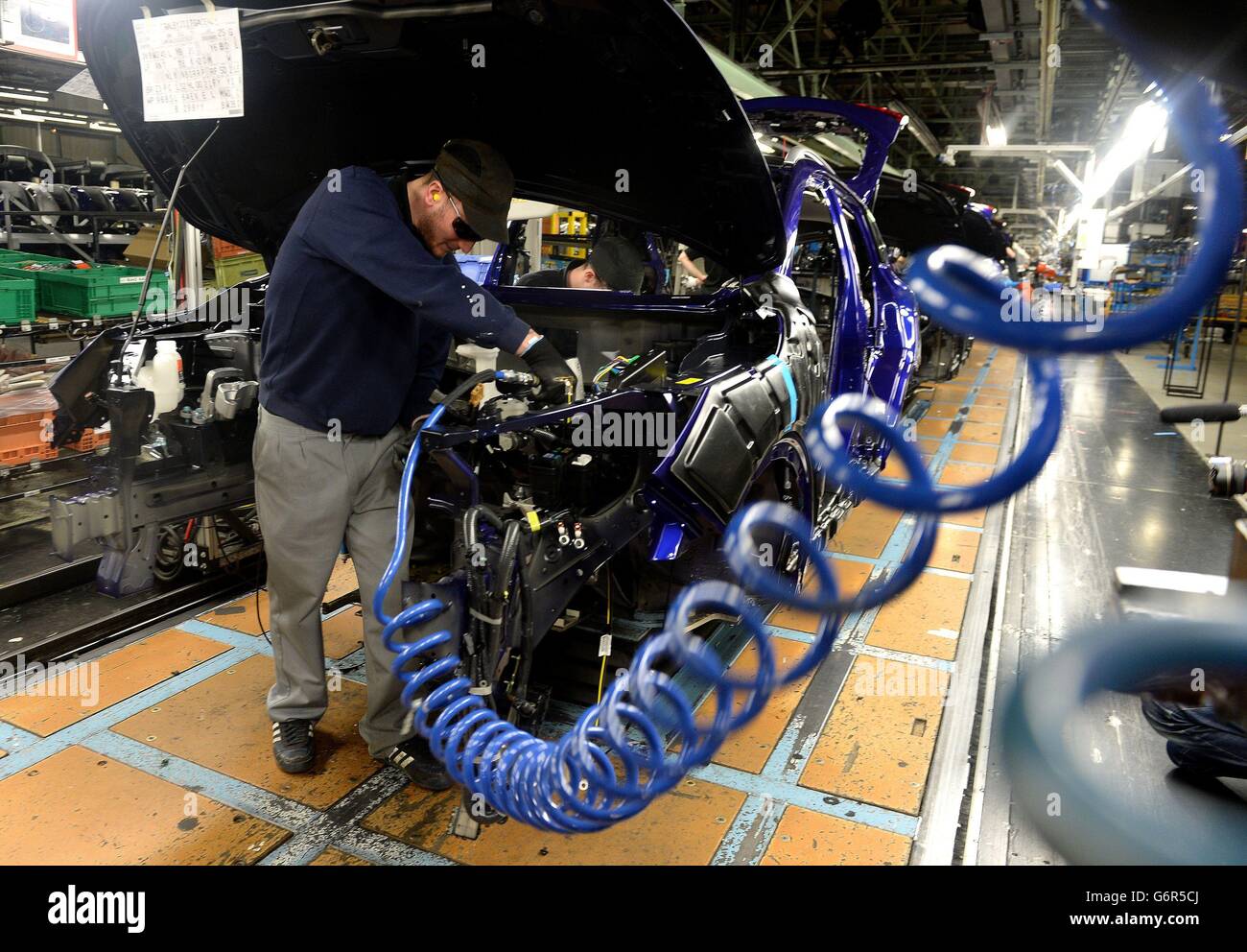 A Nissan employee works on the second generation Qashqai, at the Nissan plant in Sunderland, where the workforce is set to increase to more than 7,000 for the first time. Stock Photo