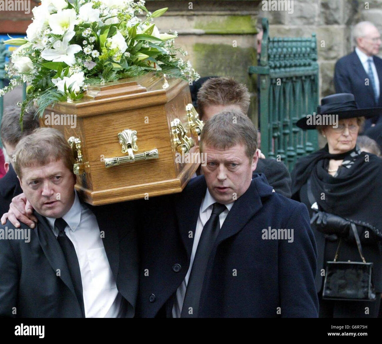 Maureen West follows behind the coffin as her husband, former Ulster Unionist leader Harry West, is carried by his sons from Enniskillen Presbyterian Church in Enniskillen, Ulster . Mr West, who was 86, died at the Erne Hospital on Thursday after a long illness. Stock Photo